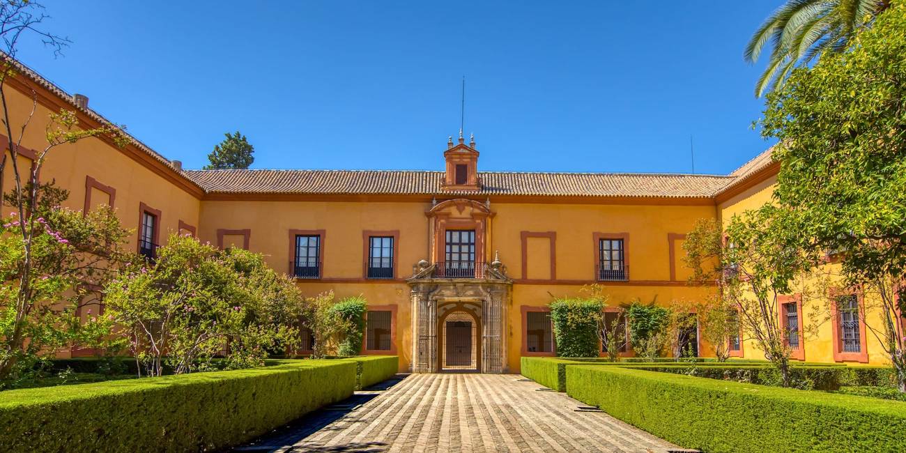 Panoramic view of the Patio de los Leones (Courtyard of the Lions) at the Alcázar of Seville, a royal palace adorned with Islamic motifs and lush gardens. Alcazar Sevilla 2025.